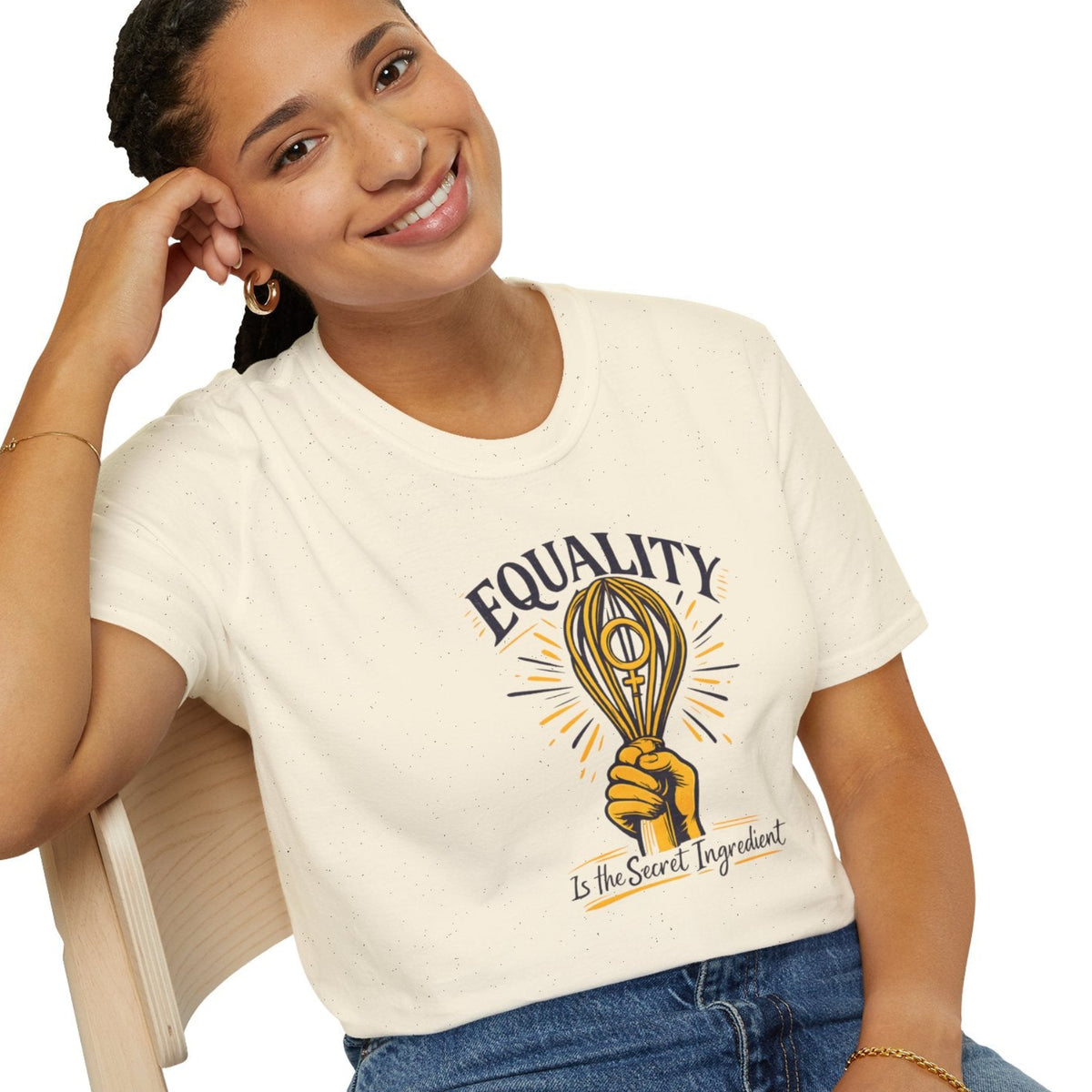Person wearing a white t-shirt with a bee graphic and 'The Change' text, sitting on a chair.