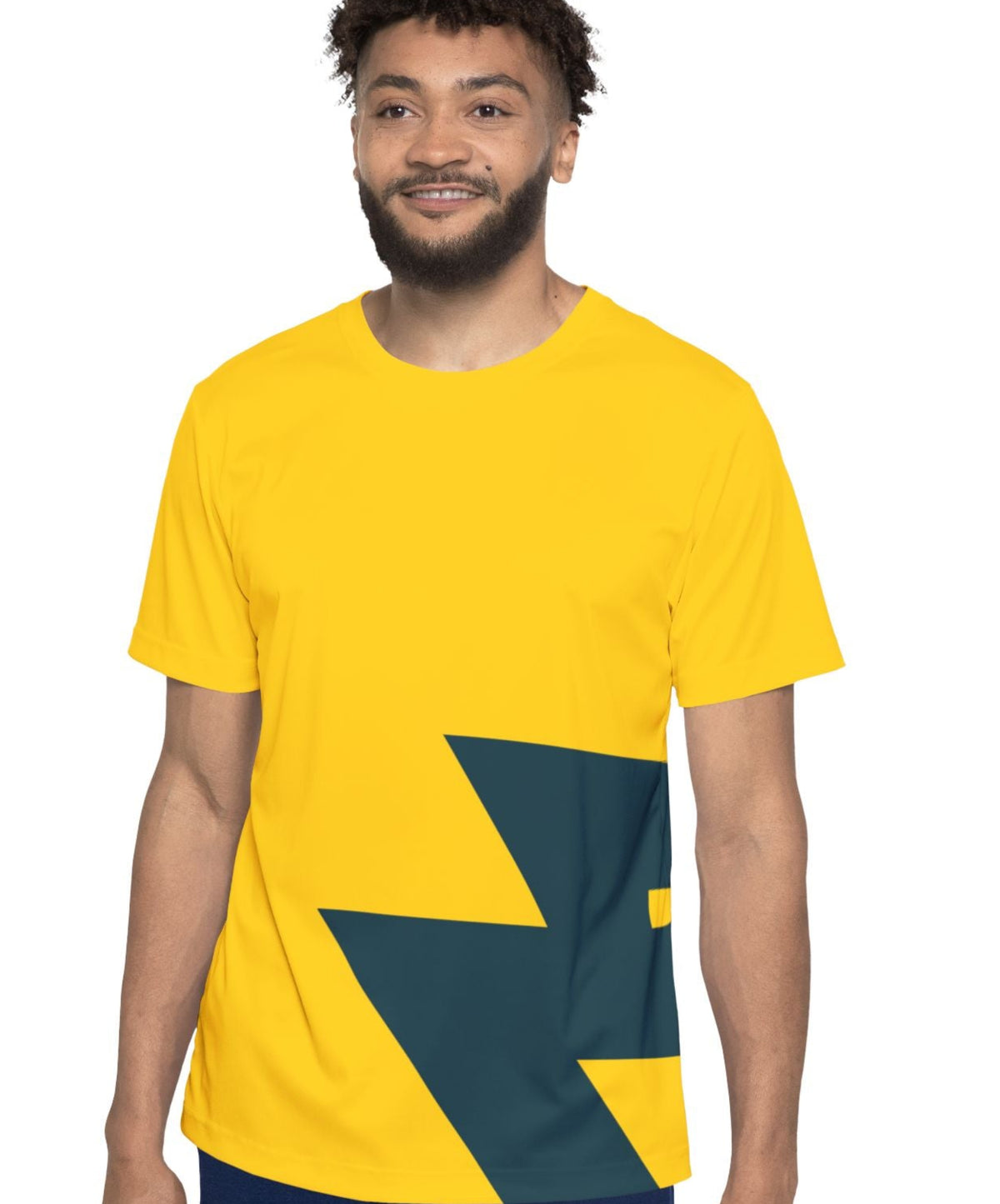 A man wearing a bright yellow t-shirt with a dark teal geometric graphic on the front, paired with navy blue pants, set against a plain white background.