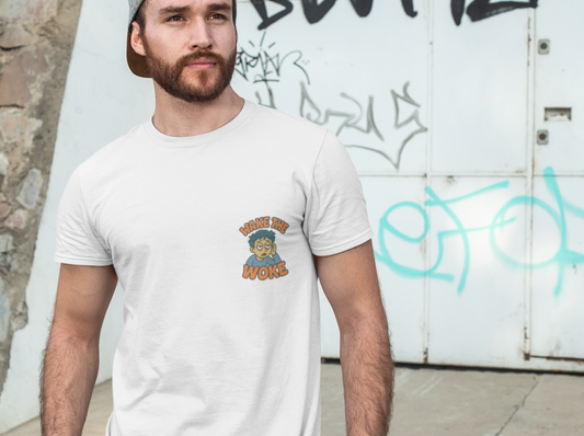 A man wearing a white crewneck t-shirt with a small graphic on the left chest, paired with a gray cap and jeans, standing outdoors against a graffiti-covered white wall.