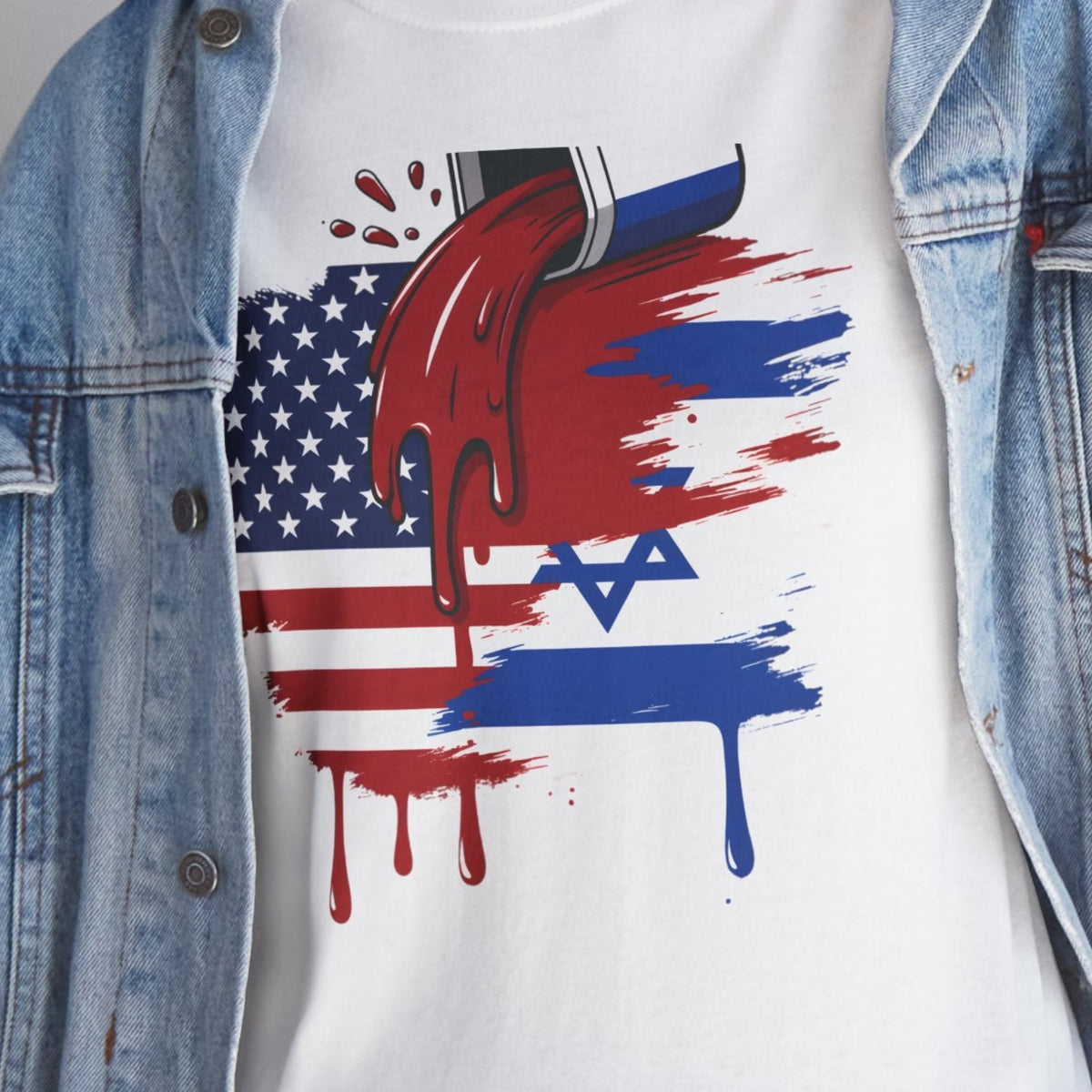A person wearing a white graphic T-shirt under an open light-wash denim jacket, paired with blue jeans. The T-shirt features a red, white, and blue graphic combining the American flag, a Star of David, and dripping paint effects.